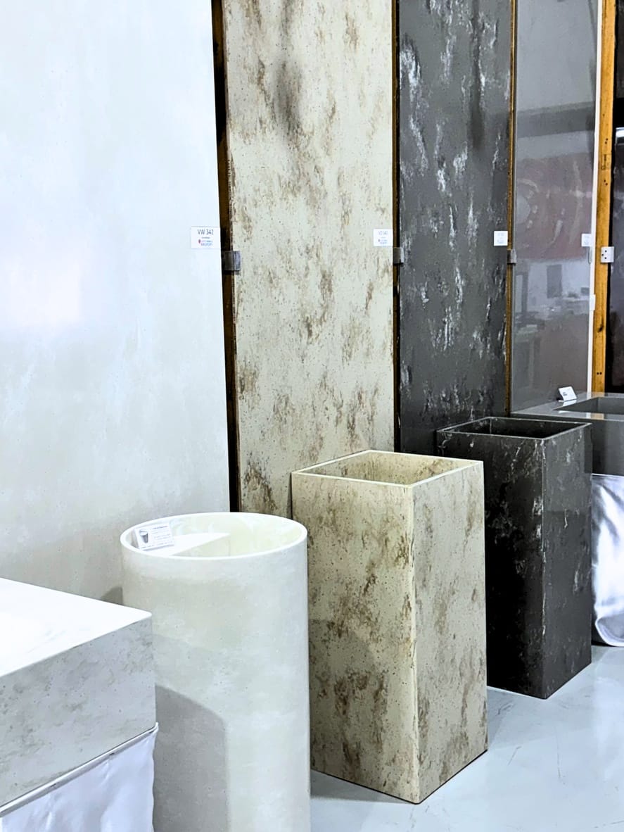 Tall solid-surface washbasins, round and square, in plain and veined colours